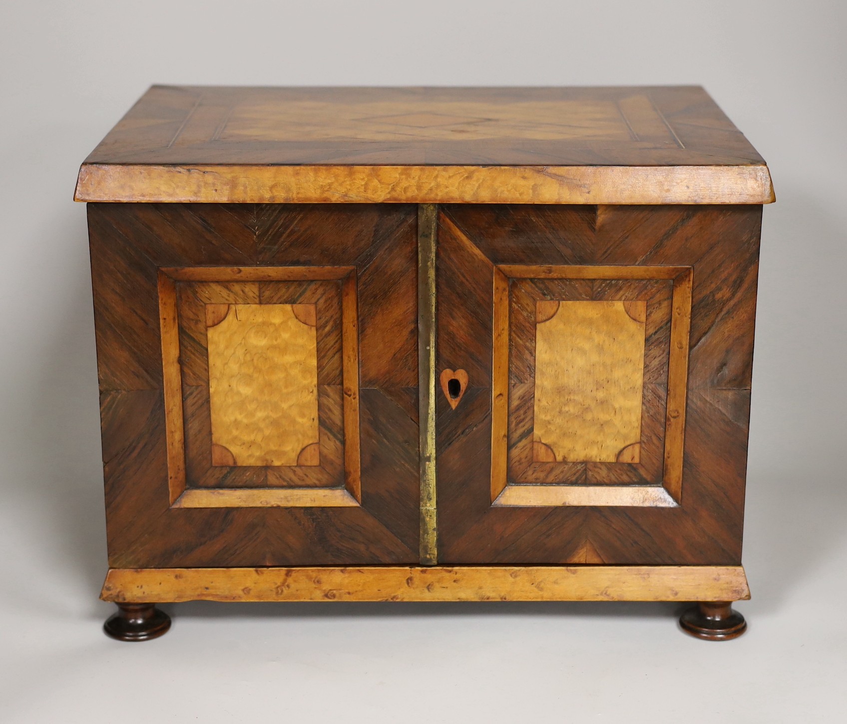A 19th century rosewood and bird’s eye maple table cabinet. 24cm high. 32cm wide, 23cm deep